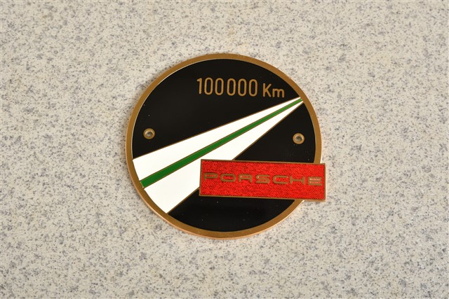 Badge 100 000 km, with fixing parts