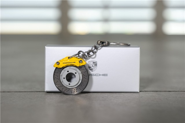 Schlüsselanhänger mit drehbarer PCCB Bremsscheibe.  3,5 cm. Gelb